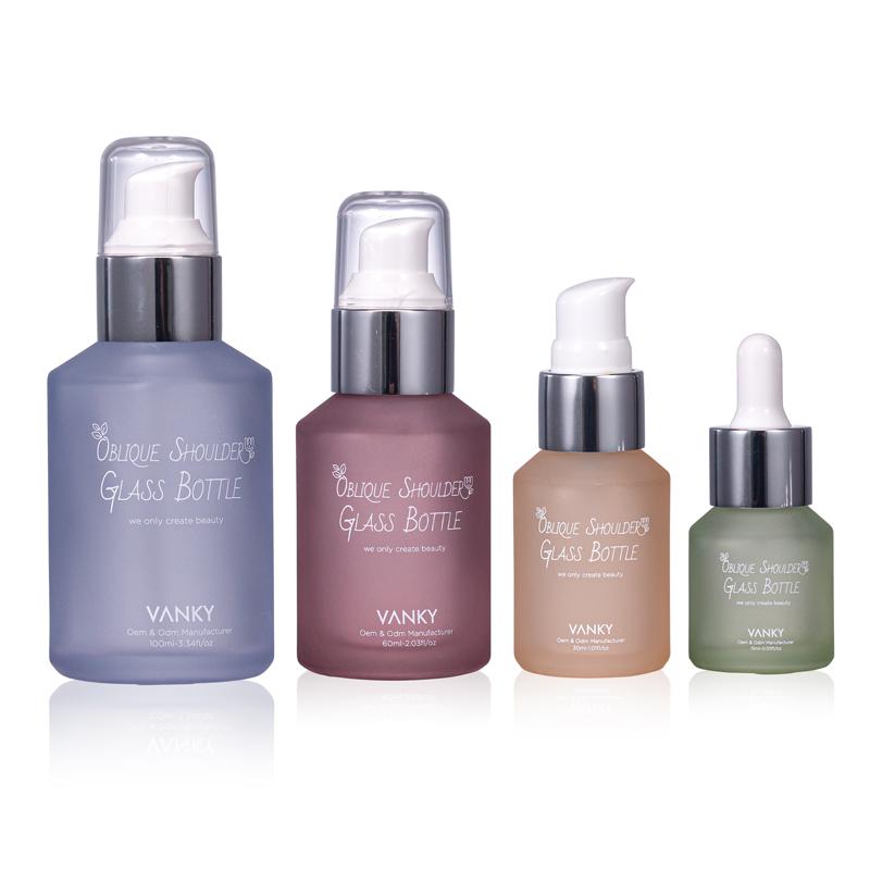 Customized matte color 15ml 30ml 60ml 100ml oblique shoulder clear glass bottle with aluminum dropper plastic lotion pump